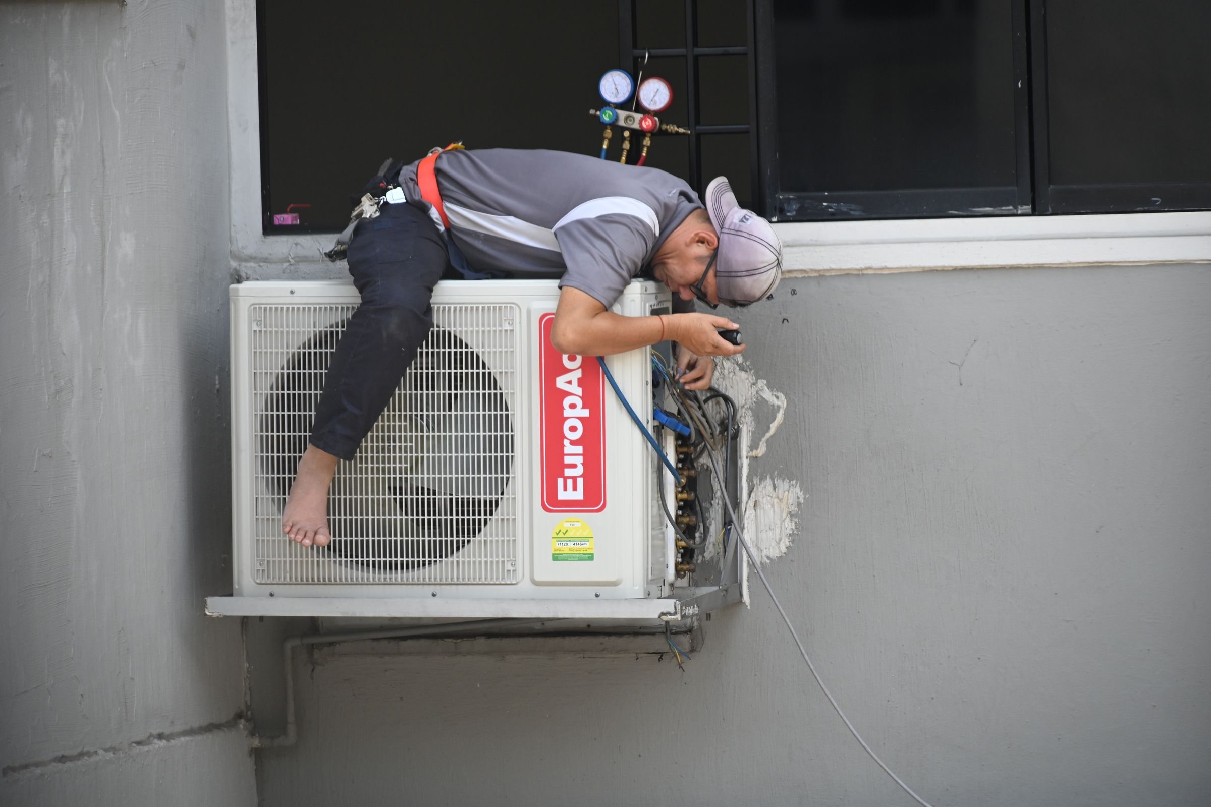 HVAC technician servicing air conditioning equipment